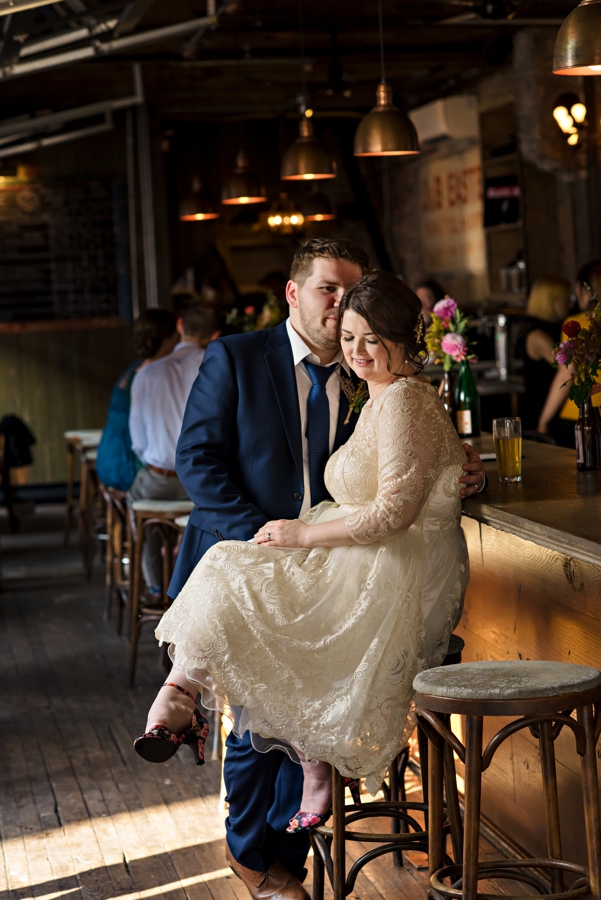 A groom kissing his bride at a south Philadelphia bar.